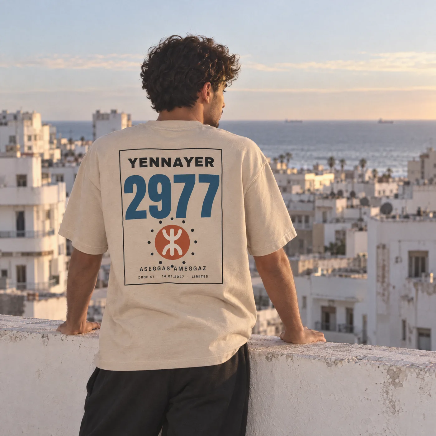 Back view of the Yennayer hoodie on a Casablanca rooftop at dusk